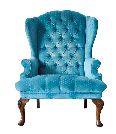 Blue velvet armchair isolated. Vintage chair with wooden legs. Insulated furniture