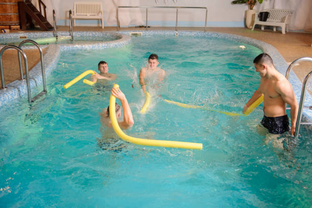 istock men relaxing in swimming pool in a spa centre 1356177326