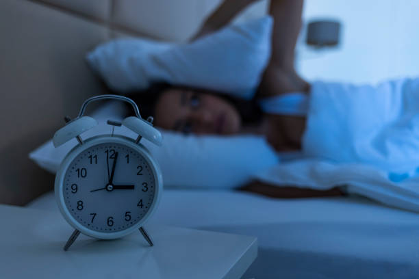 istock Woman with insomnia lying in bed with open eyes. 1356178341