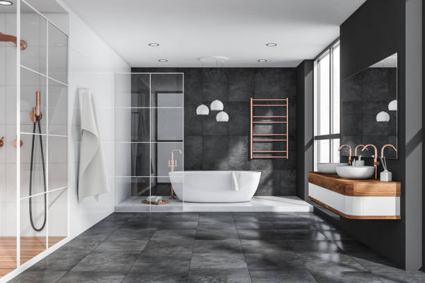 istock Grey bathroom with tiled floor and walls 1356179687