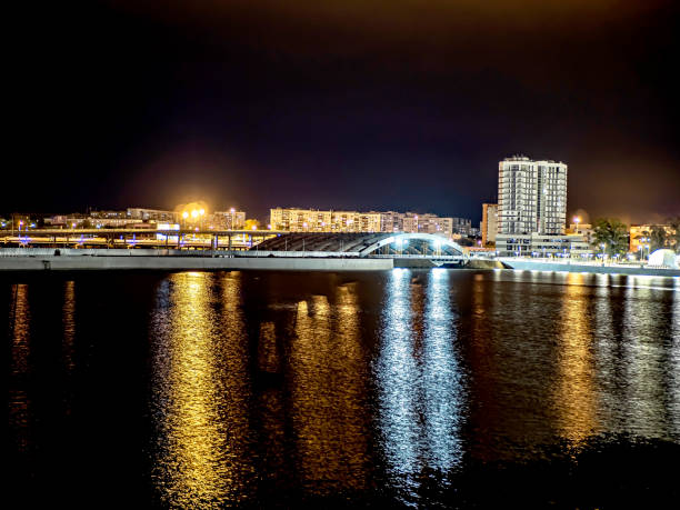 istock night river reflects the city lights brightly 1356181466