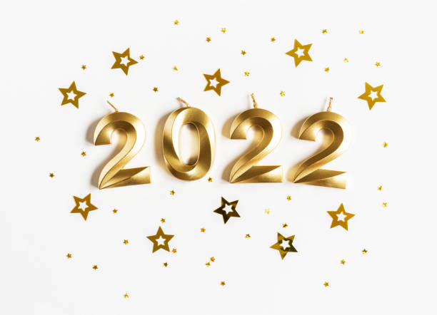 istock Greeting card - happy new year with numbers 2022, gold stars glitter on white background. 1356181572