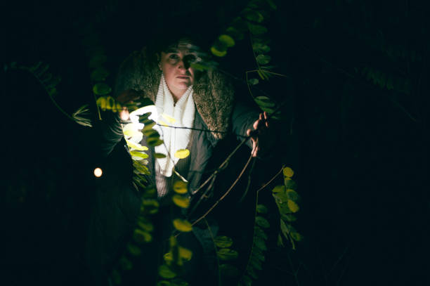 istock Woman lost in forest during nighttime 1356186367
