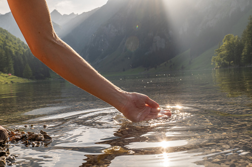 Female hand cupped catching fresh water from mountain lake
Appenzell, Switzerland