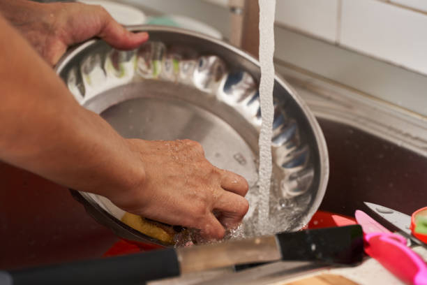 istock Woman washing dishes 1356188579