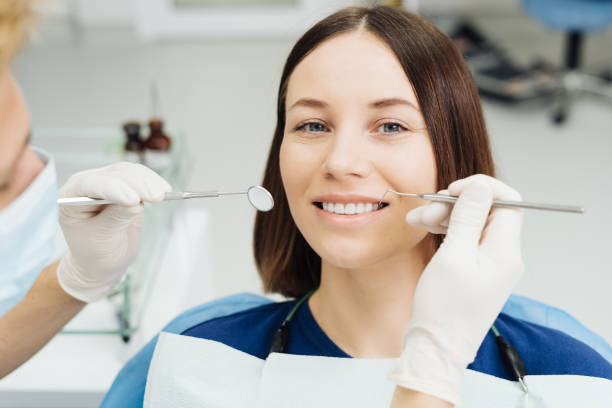 istock Dentist check patient cavity using instruments at clinic 1356188866