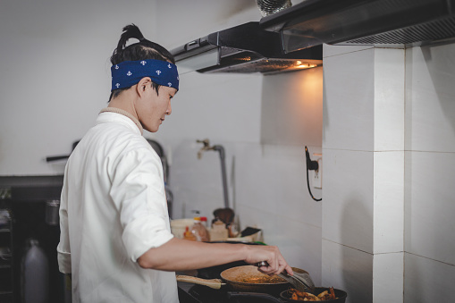 Young Male Asian Chef Cooking in the Kitchen\nChinese Chef\nVietnamese Chef