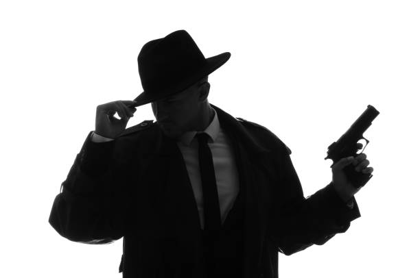 istock Old fashioned detective with gun on white background 1356190189