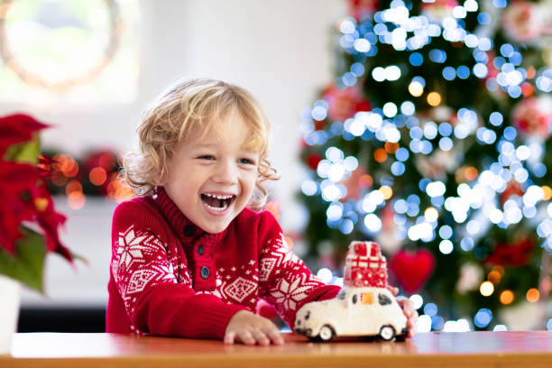 istock Child with Christmas present. Kid with Xmas gift. 1356190808