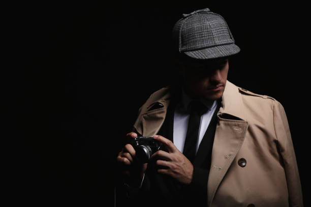 istock Old fashioned detective with camera on dark background. Space for text 1356190905