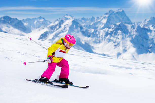 Ski and snow fun. Kids skiing. Child winter sport. stock photo