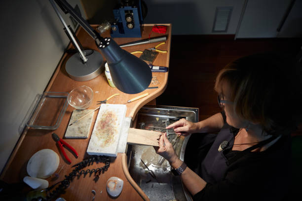 istock old woman making jewellery in her workshop 1356192106