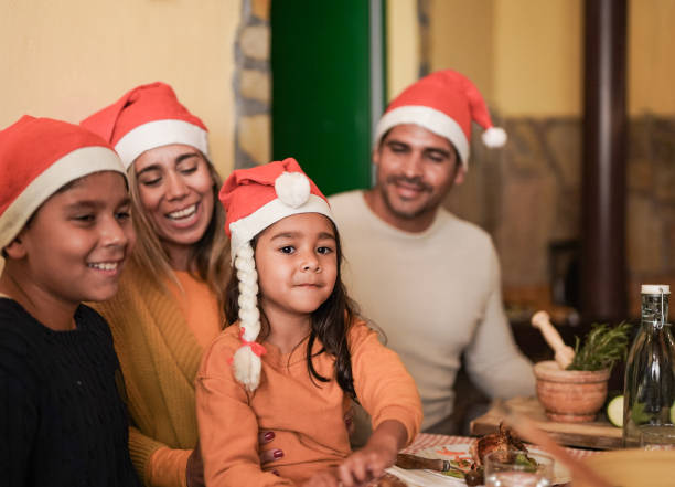 istock Latin family having fun together at christmas dinner 1356192381