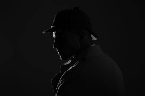 istock Old fashioned detective in hat on dark background, black and white effect. Space for text 1356192420