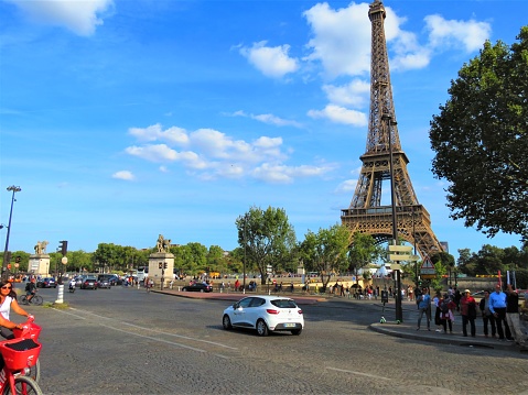 Paris, France - September 06, 2019. The Eiffel Tower on the Champ de Mars. People enjoying sunny day at the public place.