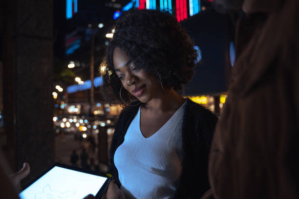 istock Woman looking at the tablet screen with pleasure smile while working with her colleagues 1356194696