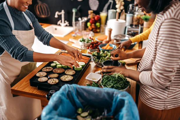 istock Three female friends cooking food in kitchen 1356198468