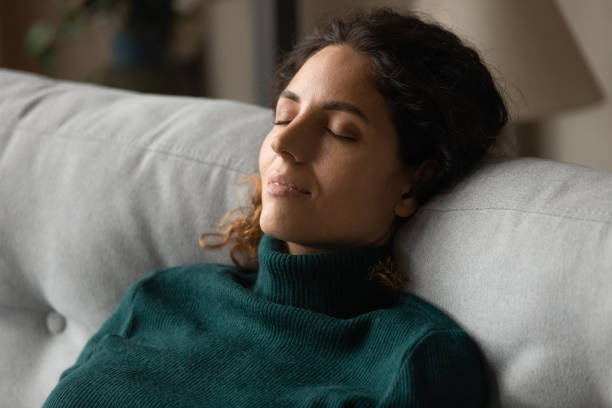 istock Calm millennial latina woman taking break for relax on couch 1356200633