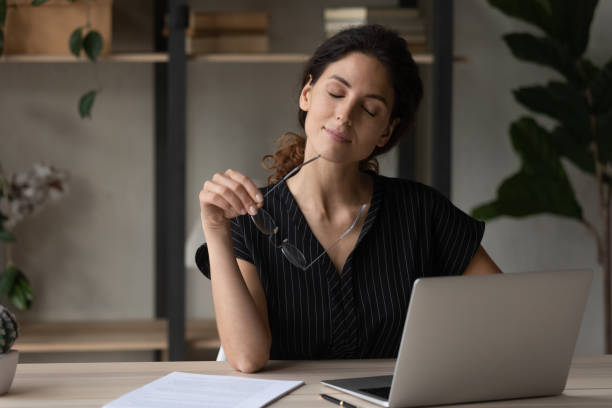 Young latina woman close eyes take break from computer work