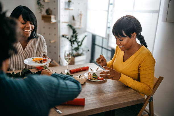 istock Three women having leisure time while having food and drinks 1356202081