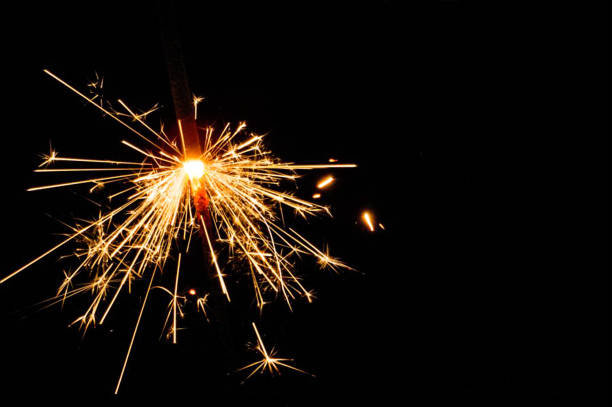 istock Burning sparklers isolated on black background 1356203122