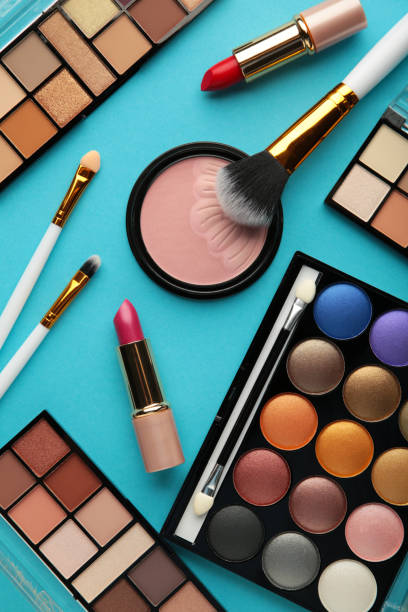 istock Set of decorative cosmetics on blue background. Vertical photo. 1356203197