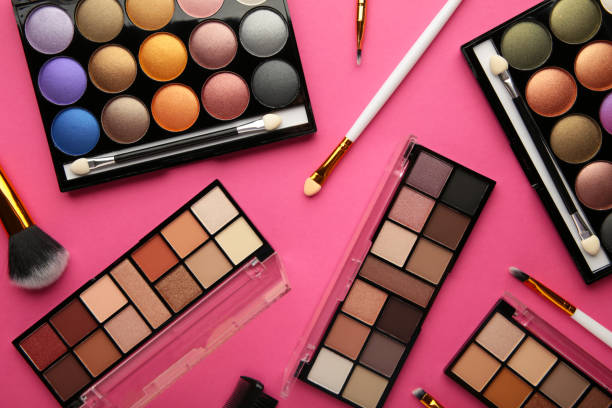 istock Professional makeup palette with brushes on pink background. 1356204366