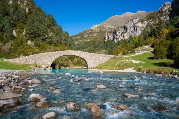 San Nicolas romanesque bridge over Ara river in Bujaruelo in Ordesa Huesca Pyrenees of Spain