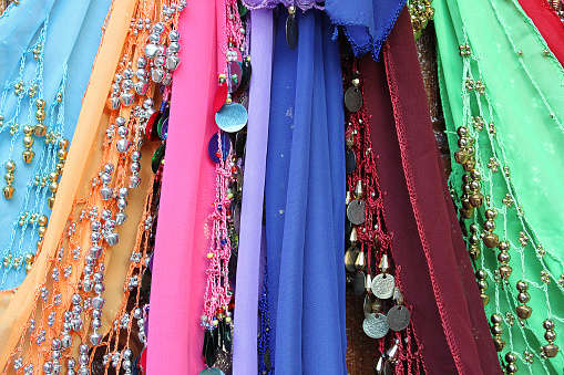 Bellydancing traditional and colorful scarves with metallic coins.