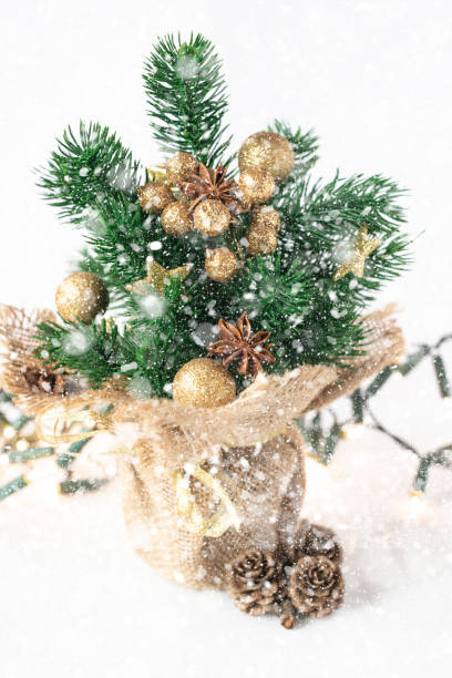 Decorative Christmas tree on a white background. Gold  Christmas decoration stock photo