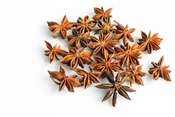 Scattered anise stars on white background stock photo