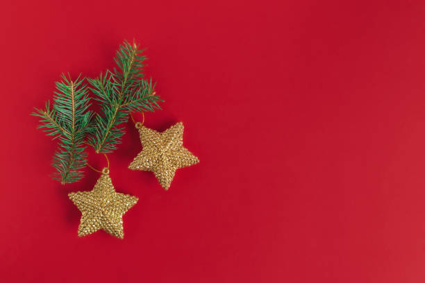 istock Spruce branches and golden ornaments on a red background. Christmas background. 1356207735
