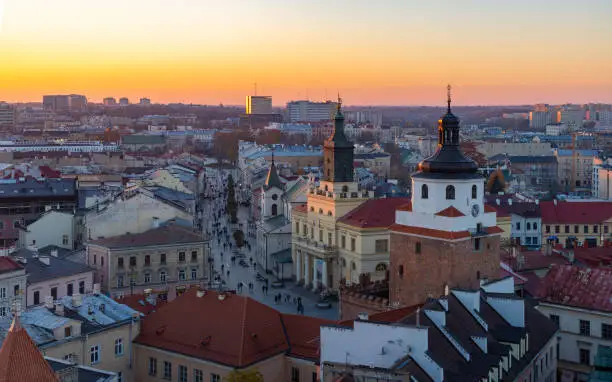 A picture of the city of Lublin at sunset, showing the Kraków Gate, the City Hall and the Kraków Suburb Street.