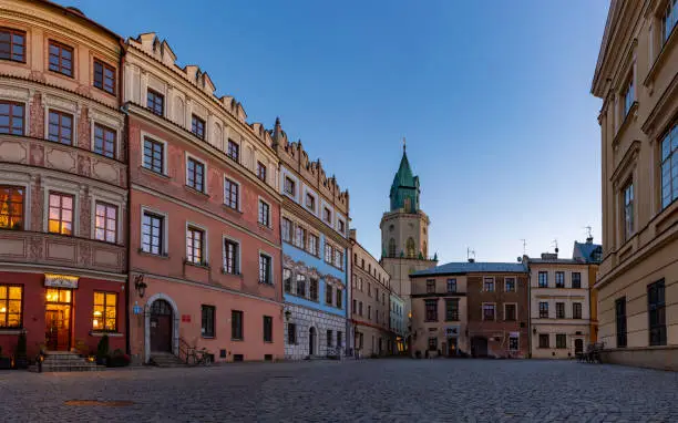 A picture of the Old Town Market Square and the Trynitarska Tower, in Lublin, at sunset.