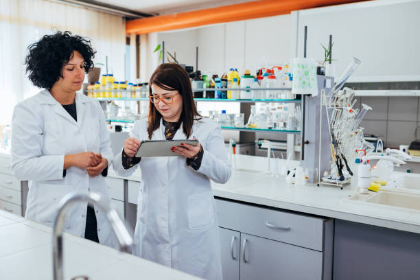 istock Two scientists are collecting data to conduct a scientific experiment in the laboratory. They use digital tablet. 1356209504