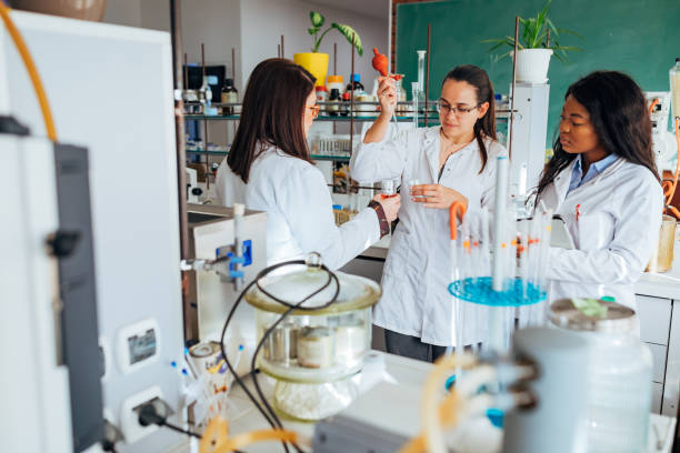 istock A small group of scientists performs an experiment of mixing the solution in the laboratory. 1356210530