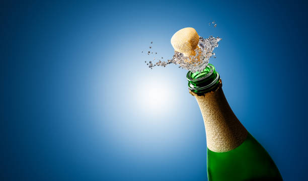 istock Champagne cork explosion, opening bottle for a new year party. 1356210578