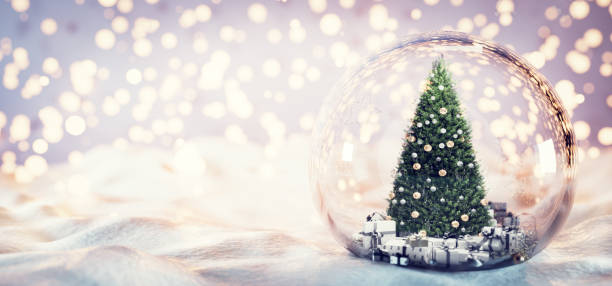istock Christmas tree in glass ball on snow. 1356210581
