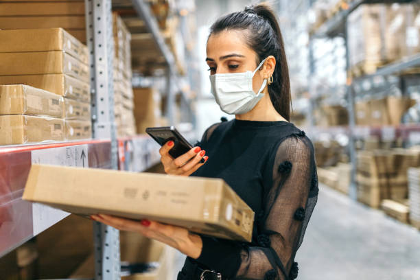 istock Young woman scanning barcode with smartphone 1356211529