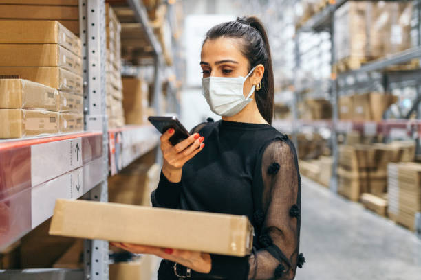 istock Young woman scanning barcode with smartphone 1356211609