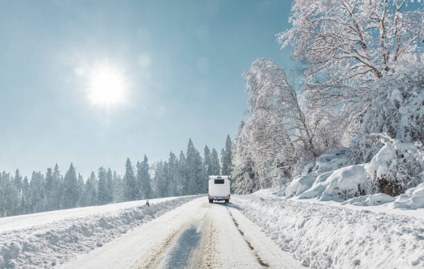 Campers on a snowy road in the mountains stock photo