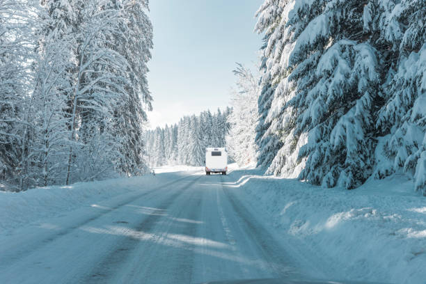 istock Campers on a snowy road in the mountains 1356213467