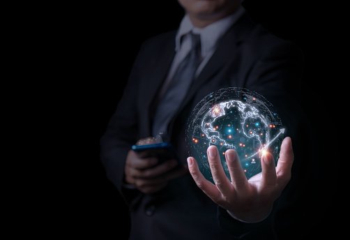 Global business world in hand. Businessman wear suit holding the planet earth on blue background. Man show world map for communicate, connection, technology, worldwide, network, internet concept.