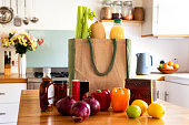 Groceries being unpacked in a modern kitchen - stock photo