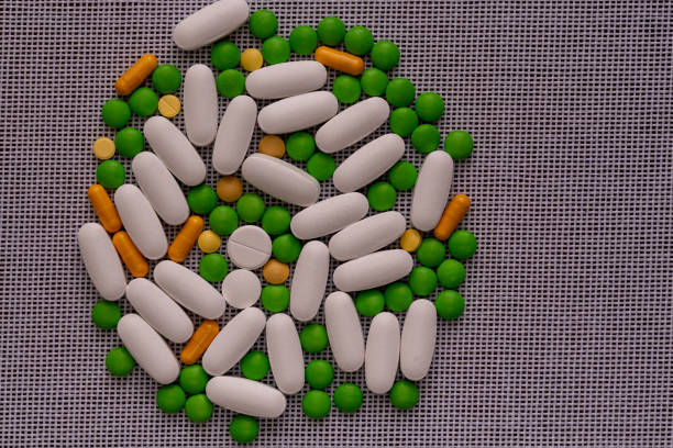 istock Tablets and capsules arranged by size. Medicine and treatment concept 1356216108