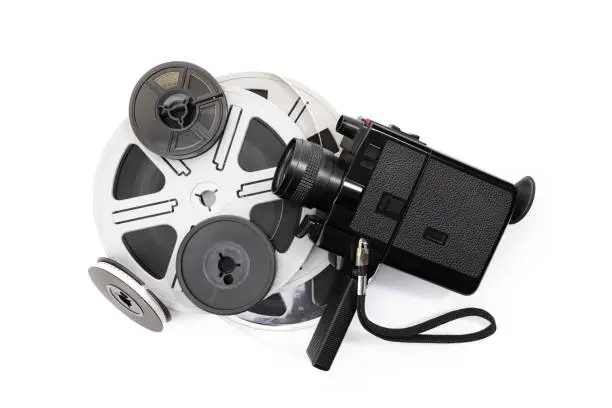 Vintage super 8 camera and film reels isolated on white background. Movie film background