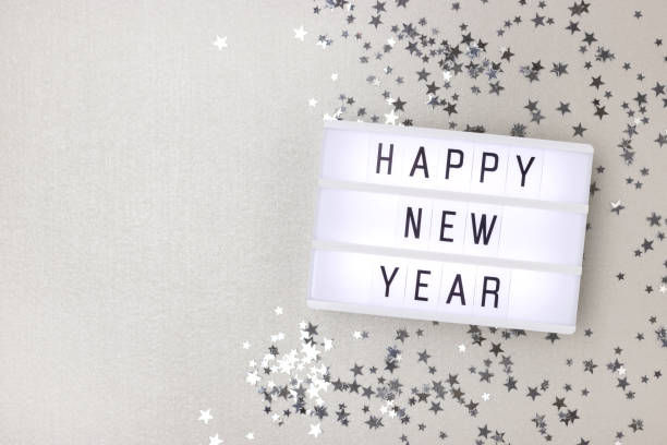 istock Happy New Year. Lightbox and silver stars confetti. 1356217318