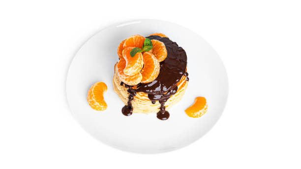 istock Pancakes with chocolate and tangerines isolated on a white background 1356217605