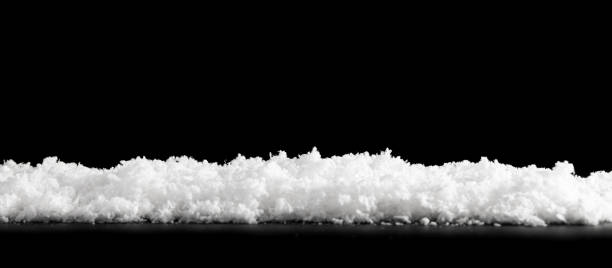 istock Close white snow isolated on black 1356218486