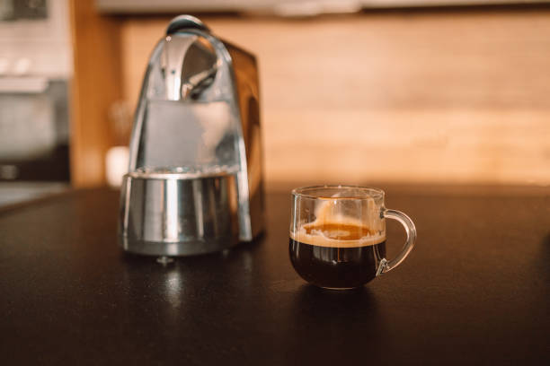 istock Cozy home desk table with modern coffee machine, glass of cup. Breakfast 1356218858